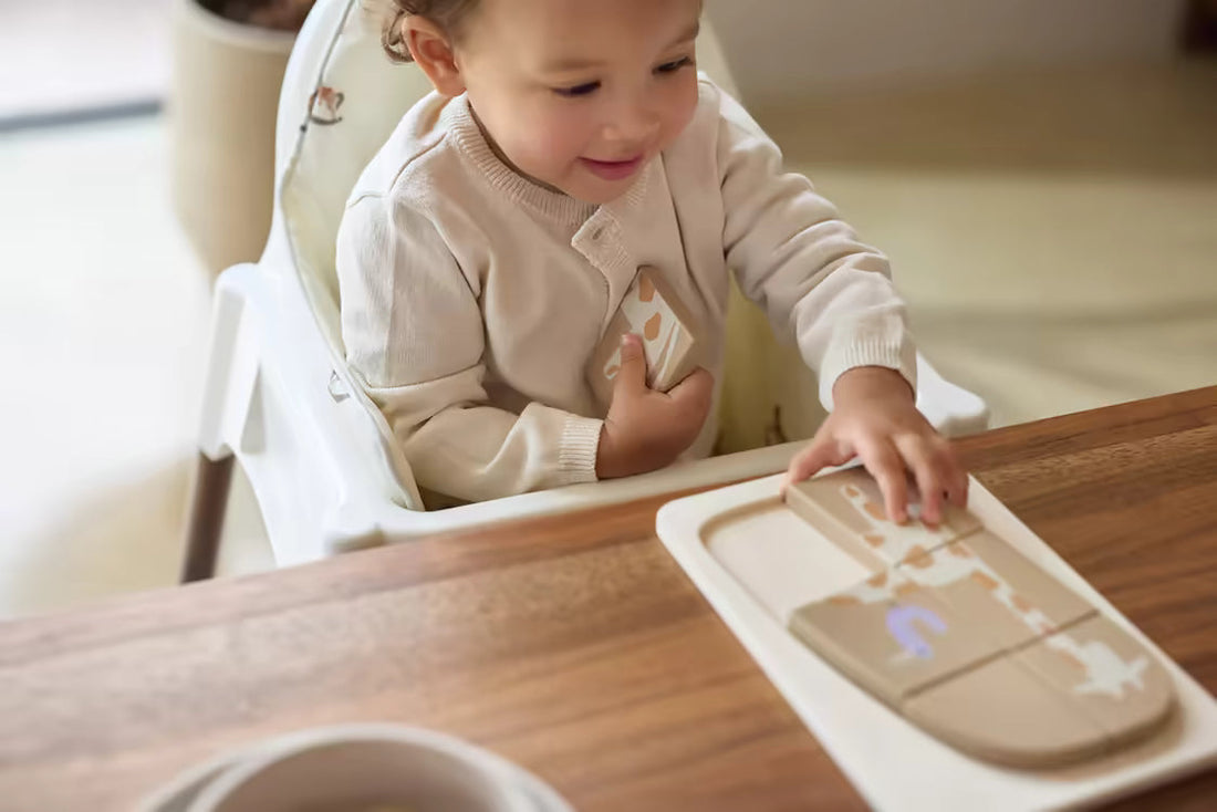 Peuter speelt zelfstandig met houten Montessori puzzel aan tafel, stimuleert concentratie en fijne motoriek.
