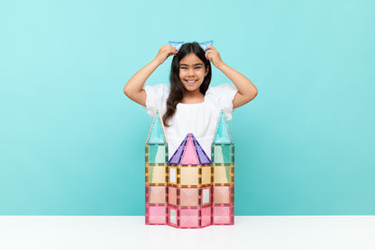 Connetix magnetische tegels kindmeisje bouwt pastel kasteel met blauwe driehoek oren op hoofd