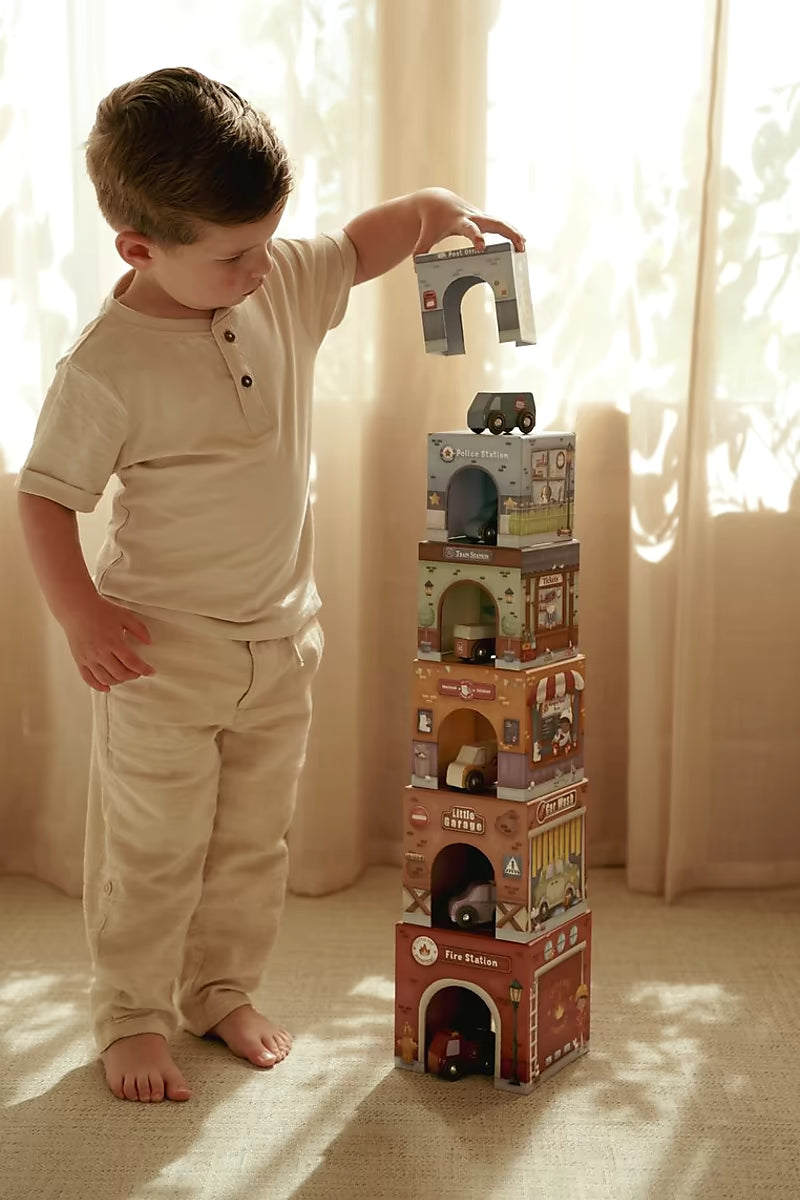 Kind speelt met Little Dutch Stapeltoren incl. 6 auto’s, stapelt en sorteert houten speelgoed op elkaar.