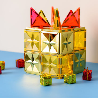 Magneet speelgoed Coblo kasteel met gouden magnetische bouwstenen, rode driehoeken en kerstcadeaus