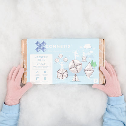 Magneet speelgoed Connetix Clear Shape Expansion Pack bovenkant doos met kinderhanden