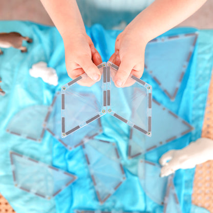 Magneet tegels Connetix close-up kinderhanden bouwen met transparante magnetische driehoek tegels