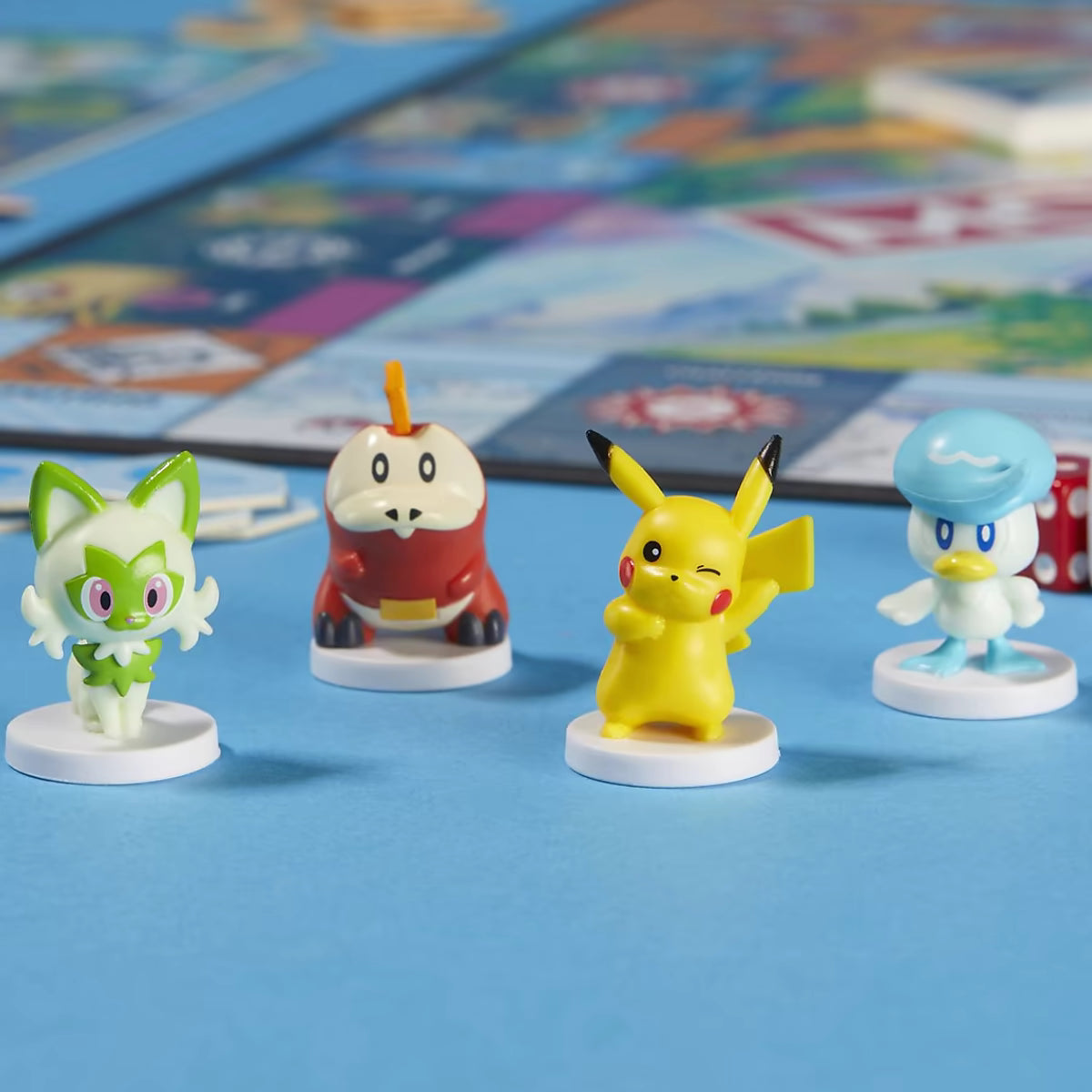 Monopoly Pokémon speelfiguren close-up: Sprigatito, Fuecoco, Pikachu en Quaxly pionnen detail